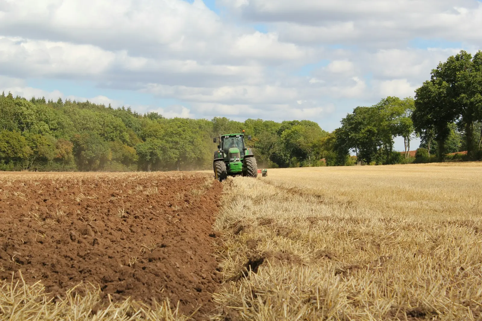 Tractor ploughing a field, turning the soil ahead of cultivation